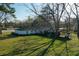 Aerial view of a quaint home with large, tree-shaded lawn, providing a peaceful, suburban atmosphere at 6156 Badham Dr, Reevesville, SC 29471