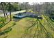 Aerial view of a single-story home with a spacious yard and mature trees, offering a private setting at 6156 Badham Dr, Reevesville, SC 29471