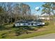 Classic single-story house featuring a white facade, set against a backdrop of lush green trees and a water tower at 6156 Badham Dr, Reevesville, SC 29471