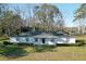 Quaint single-story home featuring a white exterior, simple landscaping, and a cozy front porch area at 6156 Badham Dr, Reevesville, SC 29471