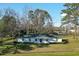 Charming single-story home featuring a classic white facade, well-maintained lawn, and mature trees at 6156 Badham Dr, Reevesville, SC 29471