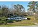 Traditional single-story home with white exterior, complemented by green lawn and mature trees in the background at 6156 Badham Dr, Reevesville, SC 29471