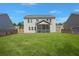Wide view of a spacious backyard featuring a lush green lawn and a charming screened in porch at 686 Redbud Ln, Summerville, SC 29486