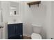Elegant powder room featuring a dark vanity, modern fixtures, and stylish decor at 686 Redbud Ln, Summerville, SC 29486