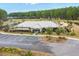 Aerial view of community center with pool, playground, parking, and lush greenery at 686 Redbud Ln, Summerville, SC 29486