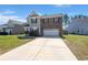 Charming two-story home with brick and siding, offering a well-manicured lawn and inviting curb appeal at 686 Redbud Ln, Summerville, SC 29486