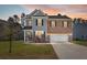 Charming two-story home with brick and siding, offering a well-manicured lawn and inviting curb appeal at 686 Redbud Ln, Summerville, SC 29486