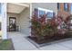 Inviting front porch featuring meticulously landscaped shrubs that enhance the curb appeal of the home at 686 Redbud Ln, Summerville, SC 29486