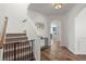 Bright hallway with wood floors, staircase, and decor, creating a welcoming entrance to the home at 686 Redbud Ln, Summerville, SC 29486