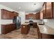 A spacious kitchen with stainless steel appliances, wood cabinets, an island, and hardwood flooring at 686 Redbud Ln, Summerville, SC 29486