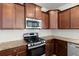 Kitchen featuring stainless appliances, wood cabinets, granite countertops, and a white tile backsplash at 686 Redbud Ln, Summerville, SC 29486