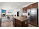 Well-lit kitchen featuring stainless appliances, a kitchen island, wood cabinets, and an open floor plan at 686 Redbud Ln, Summerville, SC 29486
