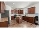 A spacious kitchen featuring wood cabinets, stainless steel appliances, a kitchen island, and hardwood floors at 686 Redbud Ln, Summerville, SC 29486
