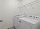 Neat laundry area with modern washer, dryer and ample shelving space at 686 Redbud Ln, Summerville, SC 29486