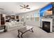 A comfortable living room featuring a fireplace, a TV, neutral furniture, and access to the kitchen and dining area at 686 Redbud Ln, Summerville, SC 29486