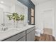 Modern bathroom featuring a double sink vanity, decorative wall art, and an open doorway at 739 Meadowbrook Ln, Summerville, SC 29486