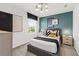 Stylish bedroom featuring modern decor, a teal accent wall, and a window view at 739 Meadowbrook Ln, Summerville, SC 29486
