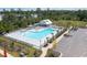 Resort-style pool with sun loungers, umbrellas, chairs, and a nearby parking lot in a gated community at 739 Meadowbrook Ln, Summerville, SC 29486