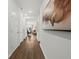 Inviting hallway with hardwood floors and modern art leading into a brightly lit living space at 739 Meadowbrook Ln, Summerville, SC 29486