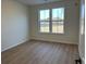 Bright bedroom with wood flooring featuring a double window and outdoor views at 752 Maynard Ln, Summerville, SC 29486