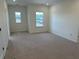 Spacious carpeted bedroom with double windows offering bright, natural light at 752 Maynard Ln, Summerville, SC 29486