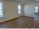 Bright bedroom with neutral walls, two windows and wood-look flooring at 752 Maynard Ln, Summerville, SC 29486