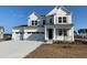 Charming two-story white home with a three car garage and inviting front porch at 752 Maynard Ln, Summerville, SC 29486