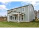 Exterior view of a two-story home featuring a covered patio, green siding, and a well-maintained lawn at 752 Maynard Ln, Summerville, SC 29486