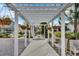 Beautiful white arbor walkway with hanging planters and stone path at 85 Arrowwood Way, Summerville, SC 29485