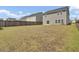 Spacious backyard with a lawn, wood fence and gray siding at 85 Arrowwood Way, Summerville, SC 29485