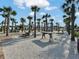 A picnic area with benches and tables beneath swaying palm trees, perfect for outdoor gatherings and relaxation at 85 Arrowwood Way, Summerville, SC 29485