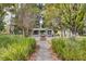 A beautifully landscaped community space with benches provides a relaxing retreat at 85 Arrowwood Way, Summerville, SC 29485