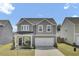 Charming two-story home boasts a well-manicured lawn and a two car garage at 85 Arrowwood Way, Summerville, SC 29485