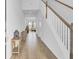 Bright foyer with hardwood floors, staircase, and views into the living area at 85 Arrowwood Way, Summerville, SC 29485