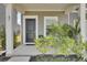 Charming front entrance with a black door, complemented by lush greenery and plants at 85 Arrowwood Way, Summerville, SC 29485