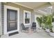 Inviting front porch with seating, a neutral rug, and potted palm trees at 85 Arrowwood Way, Summerville, SC 29485