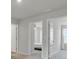 Hallway featuring neutral walls, carpet flooring, and two open doorways at 85 Arrowwood Way, Summerville, SC 29485