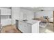 Open-concept kitchen with island, stainless steel appliances and view to the living room and dining area at 85 Arrowwood Way, Summerville, SC 29485