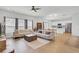 Open-concept living room with hardwood floors, abundant natural light, and modern furniture at 85 Arrowwood Way, Summerville, SC 29485