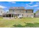 Back exterior featuring solar panels, a screened-in porch, and a spacious yard, combining comfort and sustainability at 9360 S Moreto Cir, Summerville, SC 29485