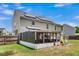 Back exterior featuring solar panels, a screened-in porch, and a spacious yard, combining comfort and sustainability at 9360 S Moreto Cir, Summerville, SC 29485