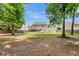 Spacious backyard with house featuring solar panels, screened-in porch and a grassy area for outdoor activities at 9360 S Moreto Cir, Summerville, SC 29485