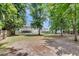 Large backyard with horseshoe pit and screened-in porch, perfect for outdoor activities and relaxation at 9360 S Moreto Cir, Summerville, SC 29485
