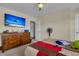 Cozy bedroom featuring a dresser with mounted TV and an adjoining room at 9360 S Moreto Cir, Summerville, SC 29485