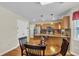 Eat-in kitchen area featuring stylish wood cabinets and a round wood dining table at 9360 S Moreto Cir, Summerville, SC 29485