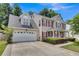 Charming two-story home with a two car garage, an American flag, and a well maintained lawn at 9360 S Moreto Cir, Summerville, SC 29485