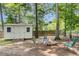 Outdoor fire pit area with comfortable seating near a shed, ideal for cozy evenings at 9360 S Moreto Cir, Summerville, SC 29485