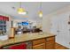 An eat-in kitchen featuring granite countertops and modern pendant lighting open to a cozy living room at 9360 S Moreto Cir, Summerville, SC 29485
