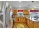 Well-lit kitchen with stainless steel appliances, granite countertops, and wood cabinetry at 9360 S Moreto Cir, Summerville, SC 29485