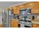 Functional kitchen space with stainless steel appliances, granite countertops, and ample storage at 9360 S Moreto Cir, Summerville, SC 29485